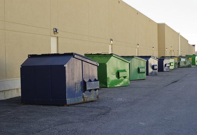 a row of large construction dumpsters on-site in Grand Forks